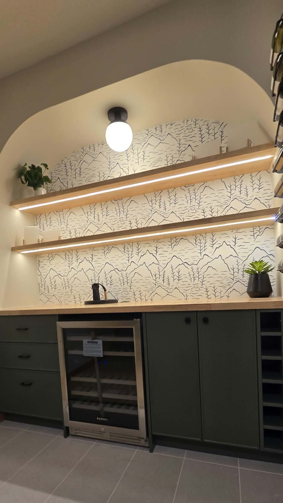 A beautiful picture of the led lights installed under the shelving units.